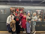 People dessed up in amazing costumes posing next to the NYCTA Holiday Train at 2nd Avenue Station on Manhattans Lower East Side